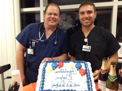 Dr. Derkum next to another man with a birthday cake 